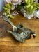 Hand candlestick, peacock shape, in bronze