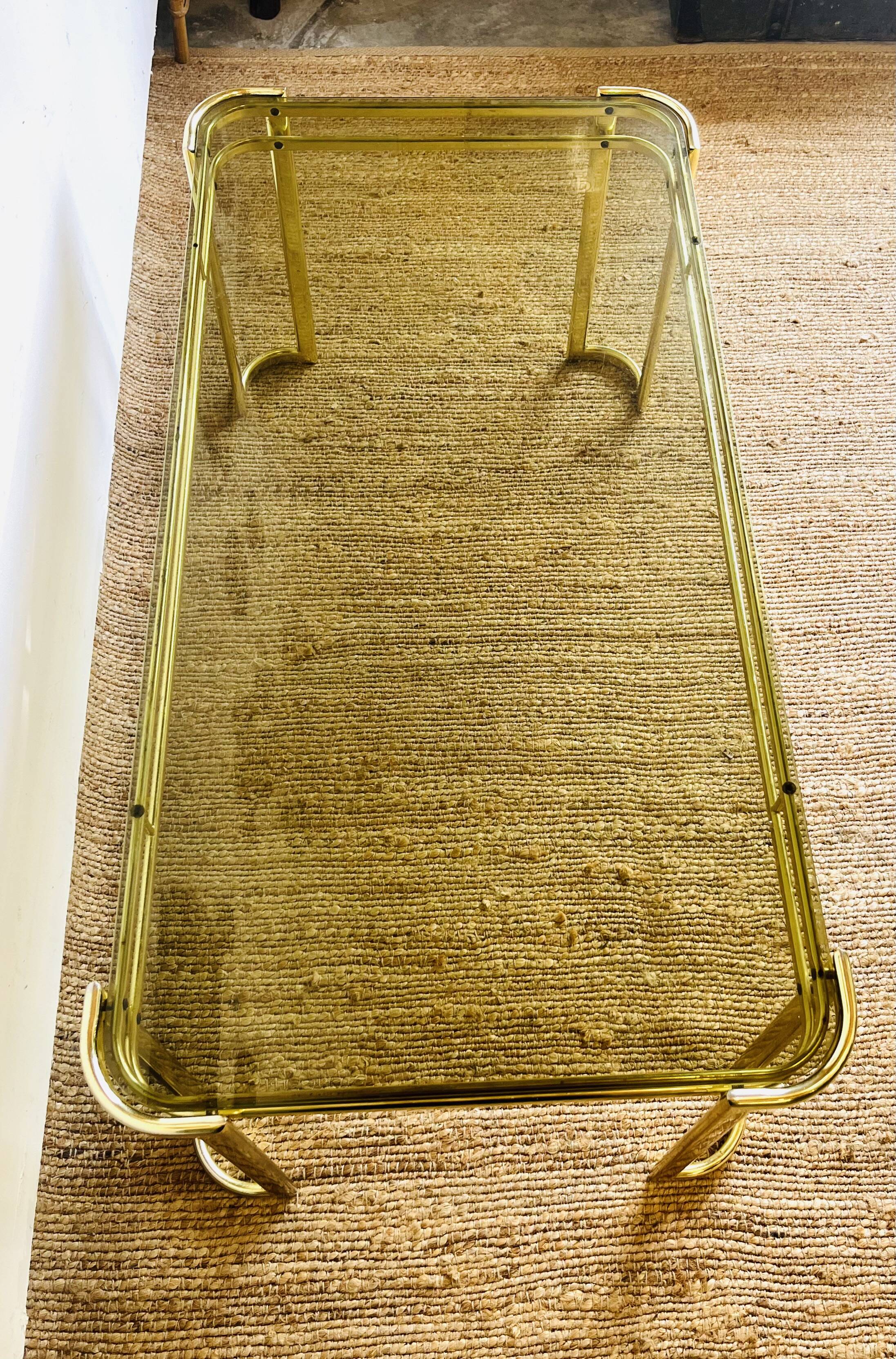 Gold metal and smoked glass coffee table – 1970s-624001