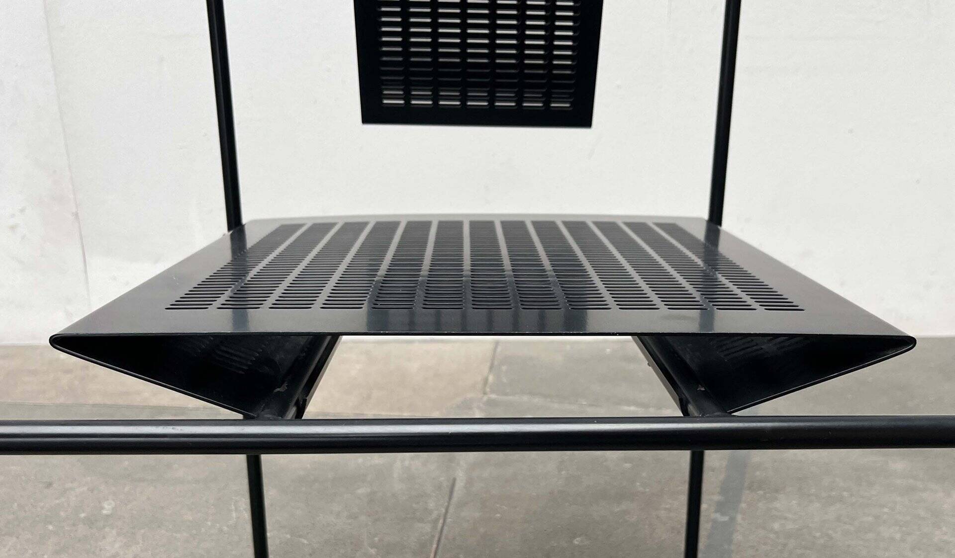 Postmodern black Quinta chair in perforated metal by Mario Botta for Alias, 1980s.