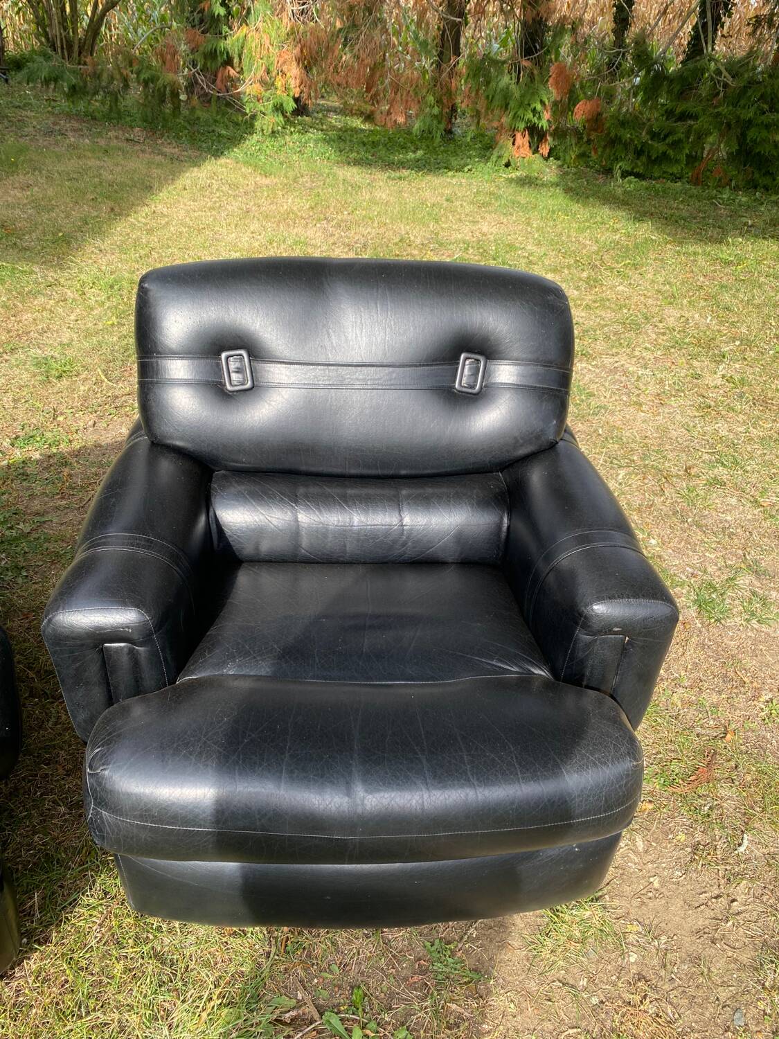 Pair of black imitation leather armchairs