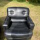 Pair of black imitation leather armchairs