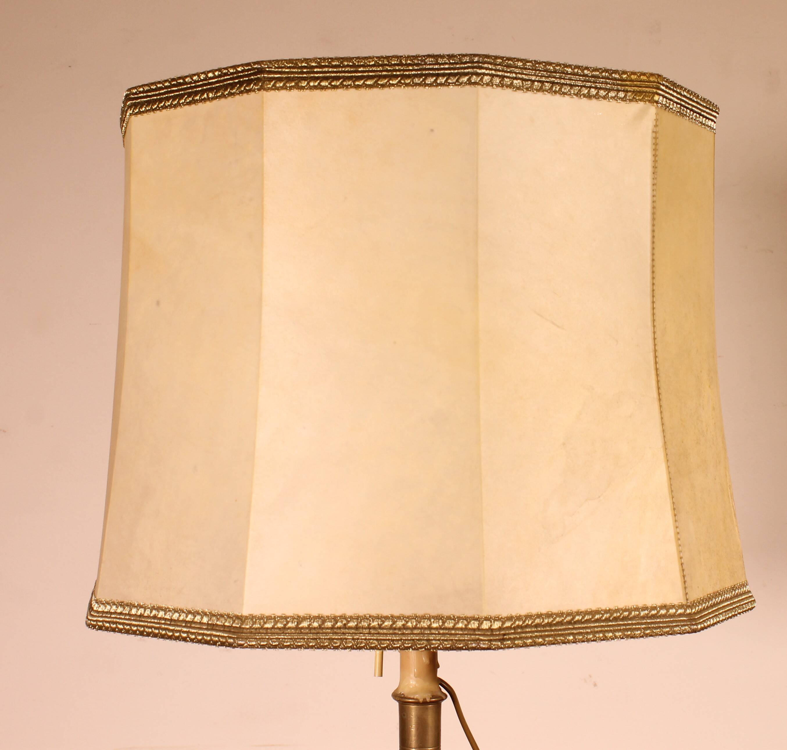 bronze candlestick from the 17th century converted into a lamp with its lampshade