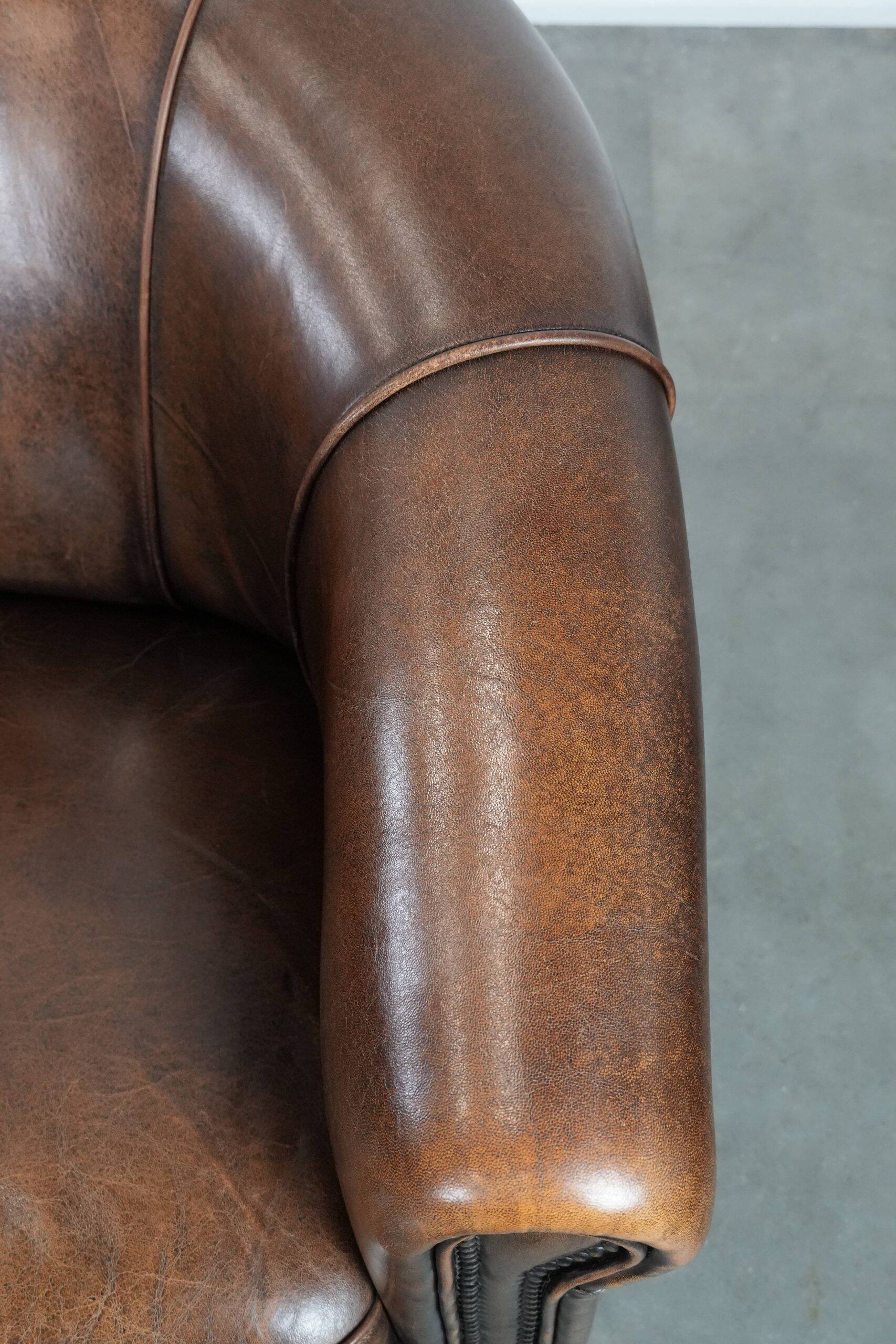 Set of two sheepskin club armchairs with fixed seat cushions