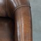Set of two sheepskin club armchairs with fixed seat cushions