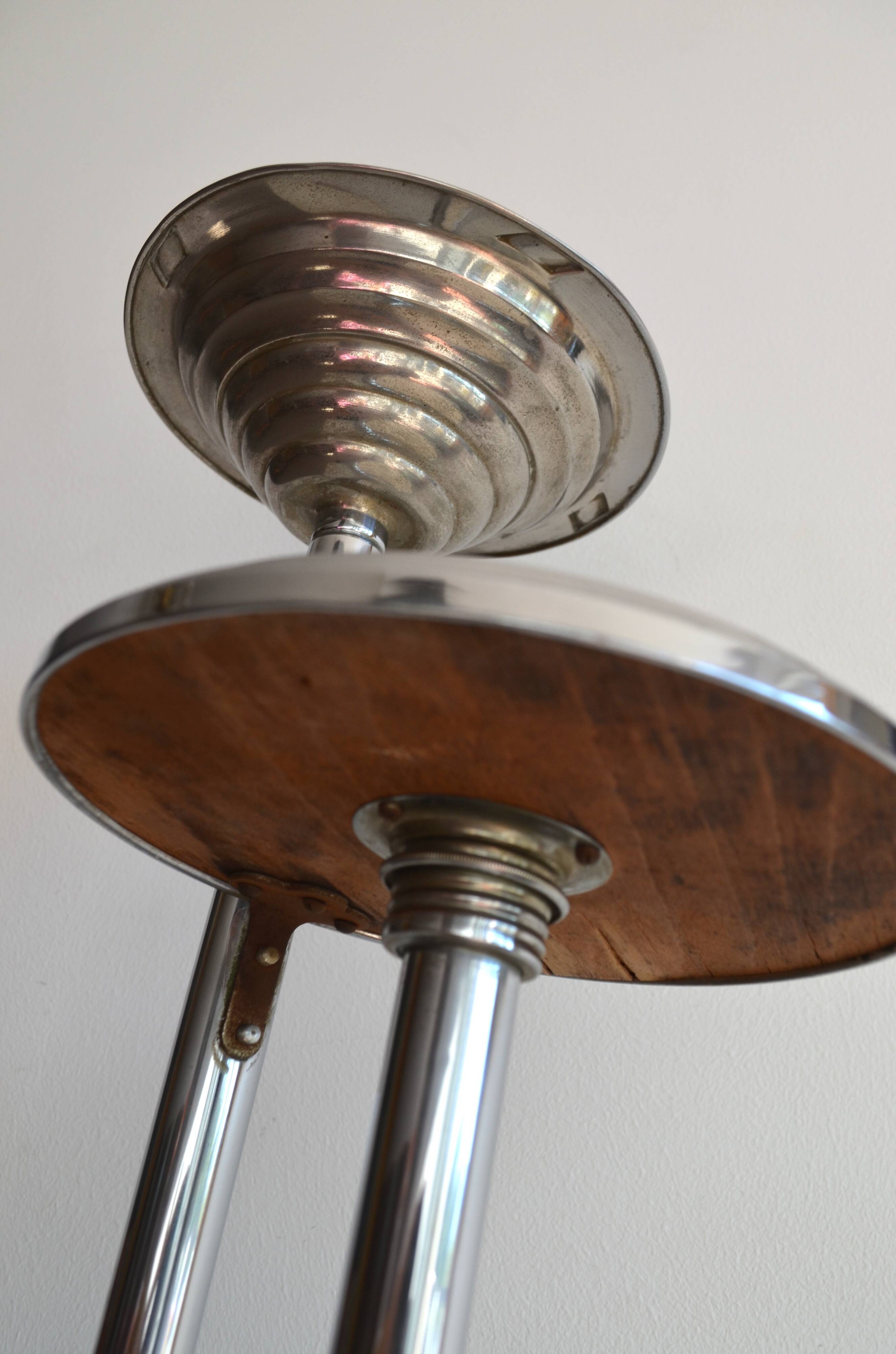 Ashtray and shelf on chrome metal stand.
