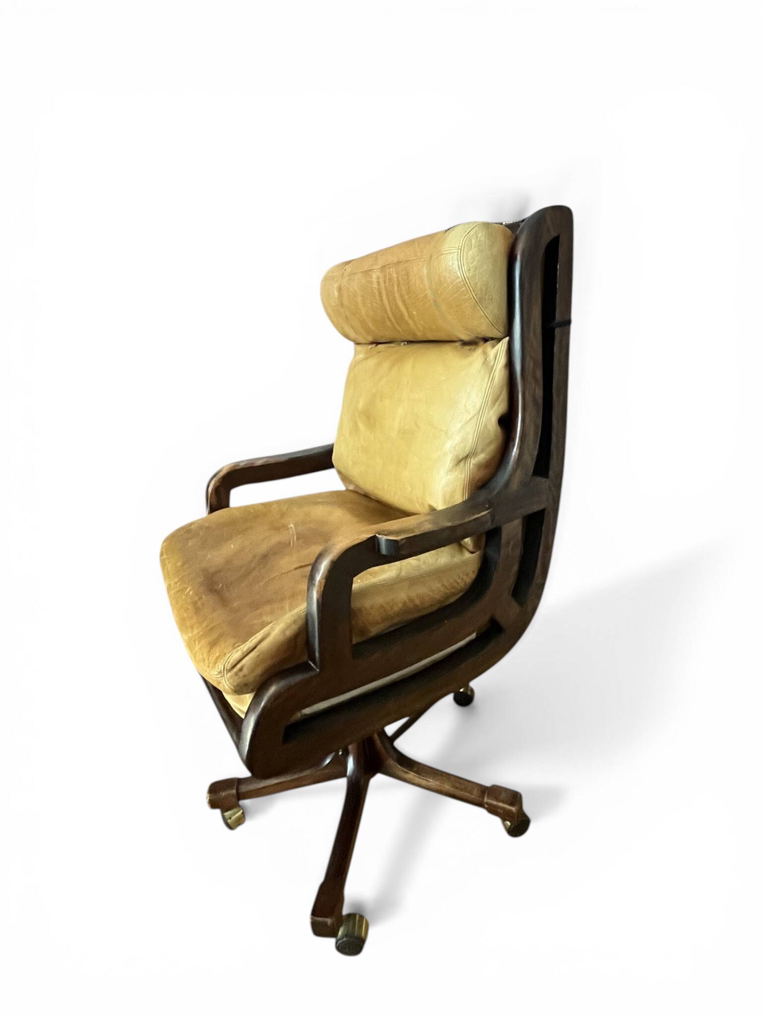 Vintage mahogany and havana leather office chair with wheels from around 1970.