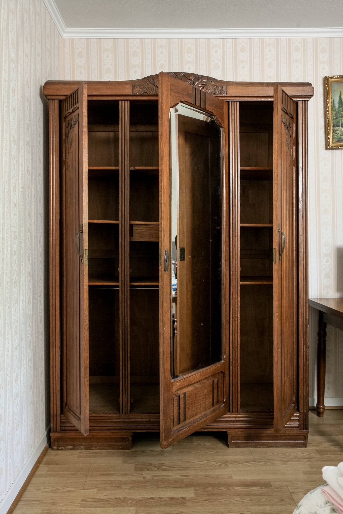 Old solid wood wardrobe with three vintage mirror doors