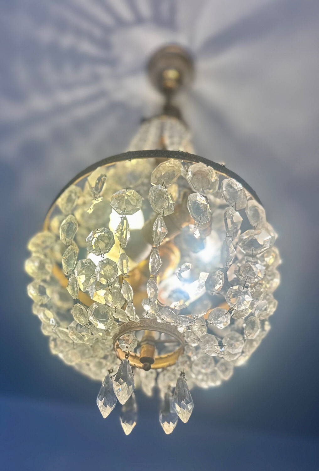 Basket chandelier with crystal and gilded brass pendants, circa 1930.