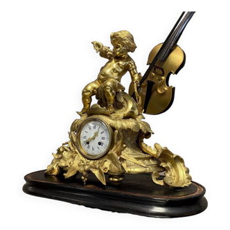 Clock with a cherub musician in gilded bronze circa 1850