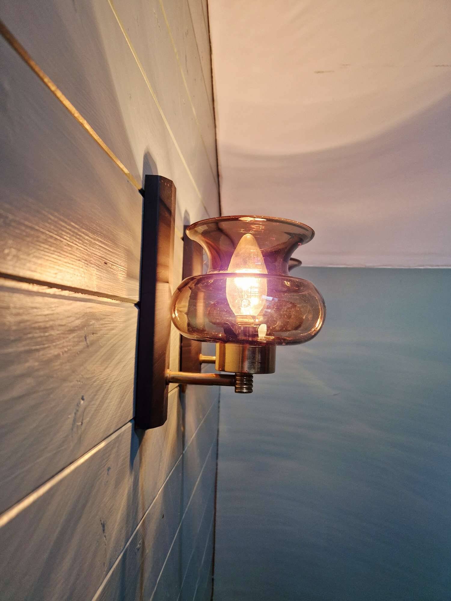 Pair of wall sconces in brass and smoked glass, 1960s.