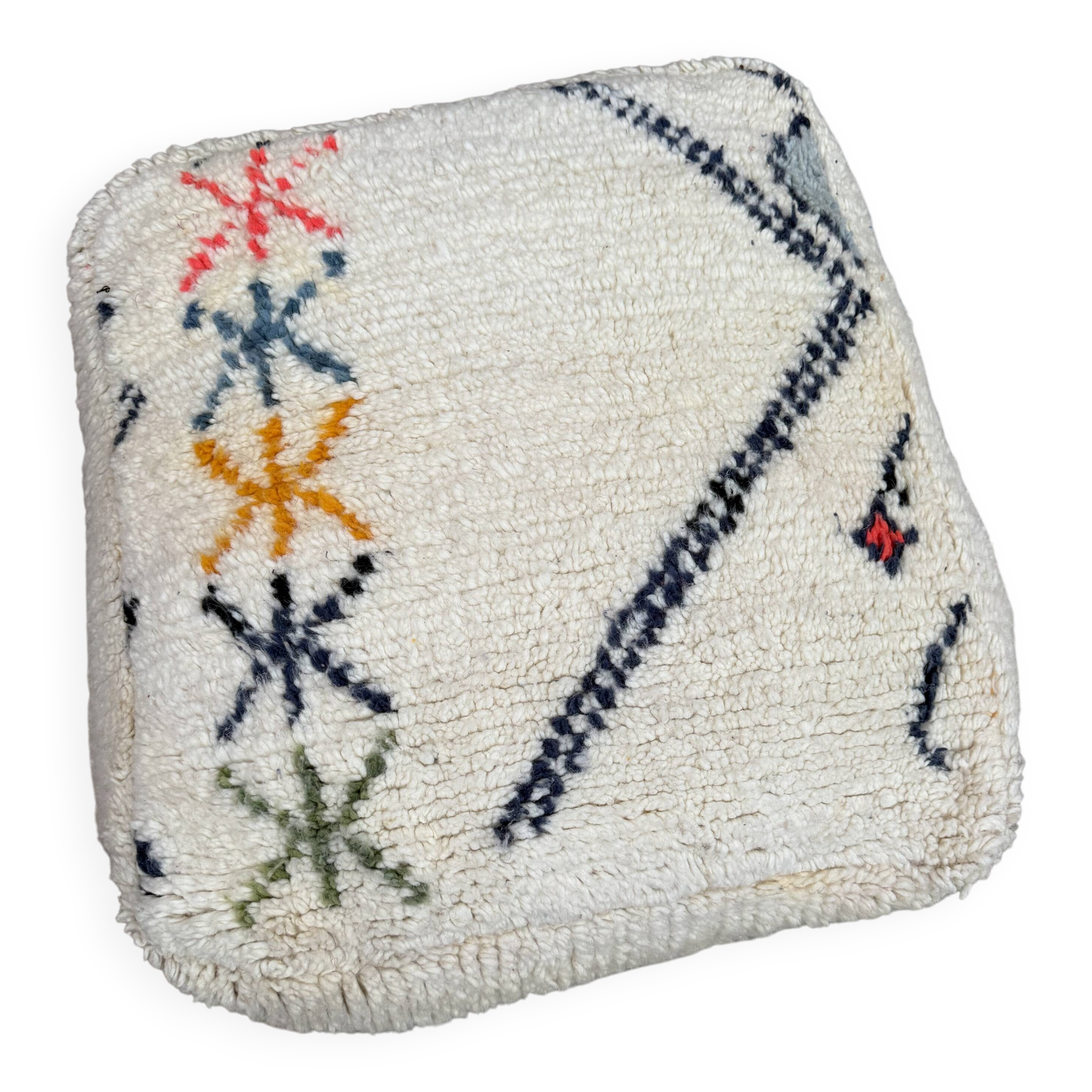 Berber floor pouf: Handwoven Moroccan wool cushion.