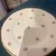 Dessert plate and porcelain dishes with a multicoloured floral pattern, vintage.