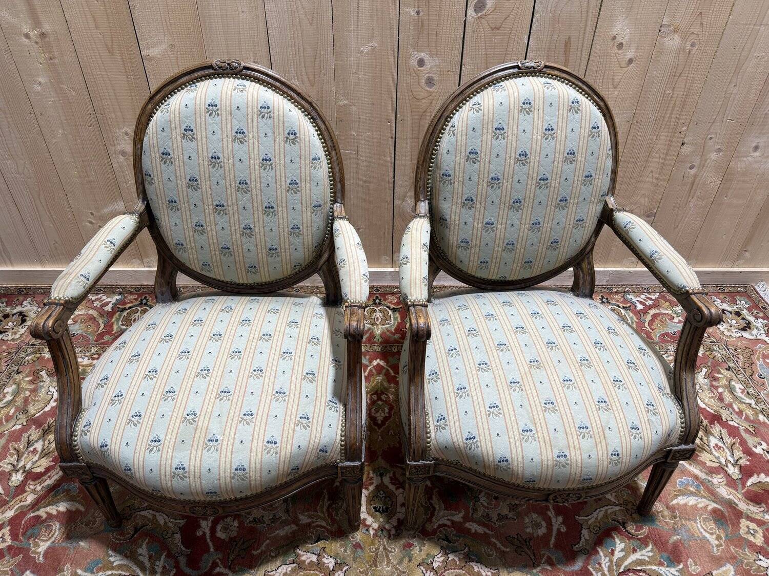 Pair of cabriole armchairs with medallion backs from the Louis XVI period, stamped OT.