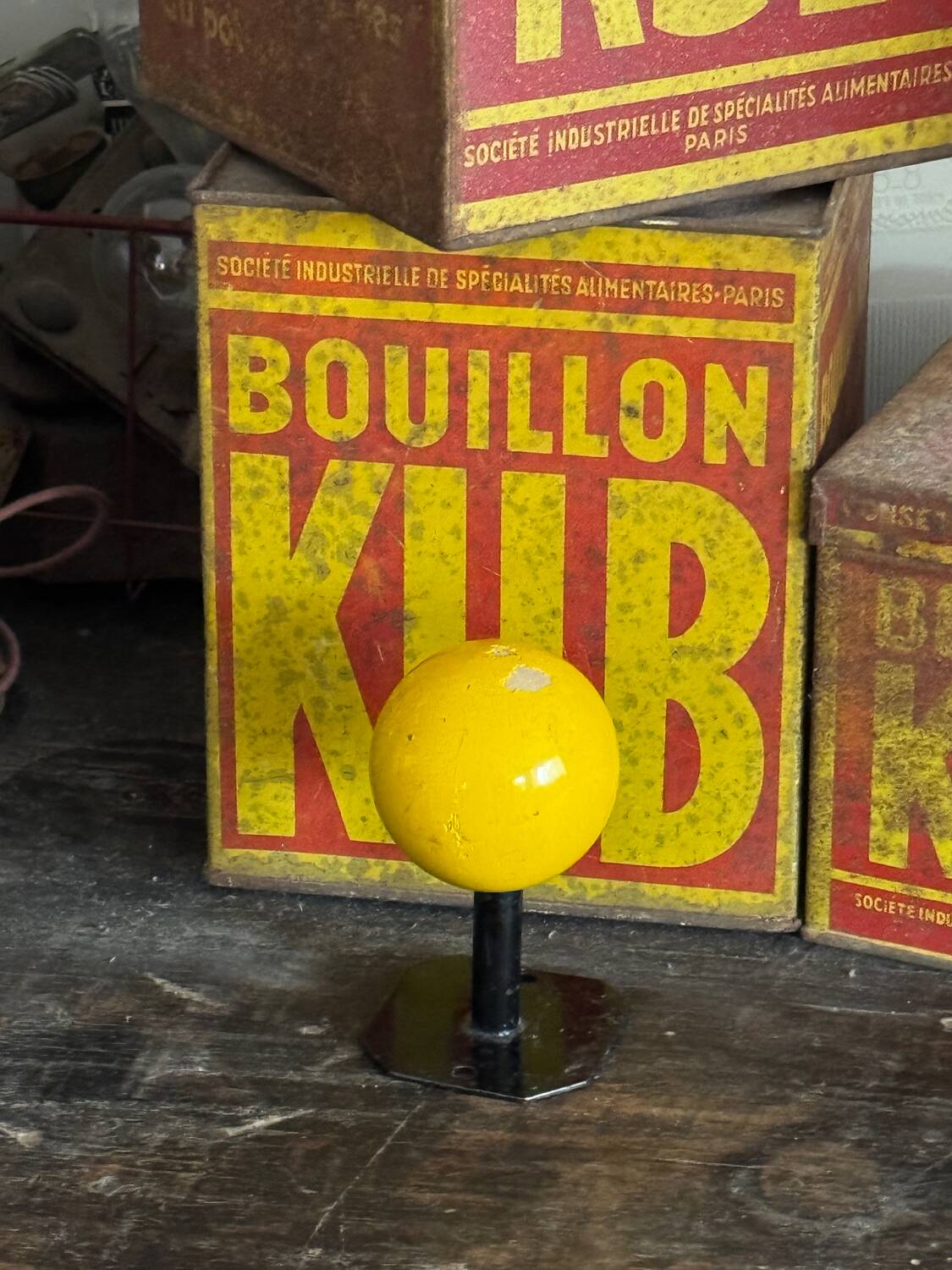 Vintage yellow wooden wall-mounted ball coat hook.