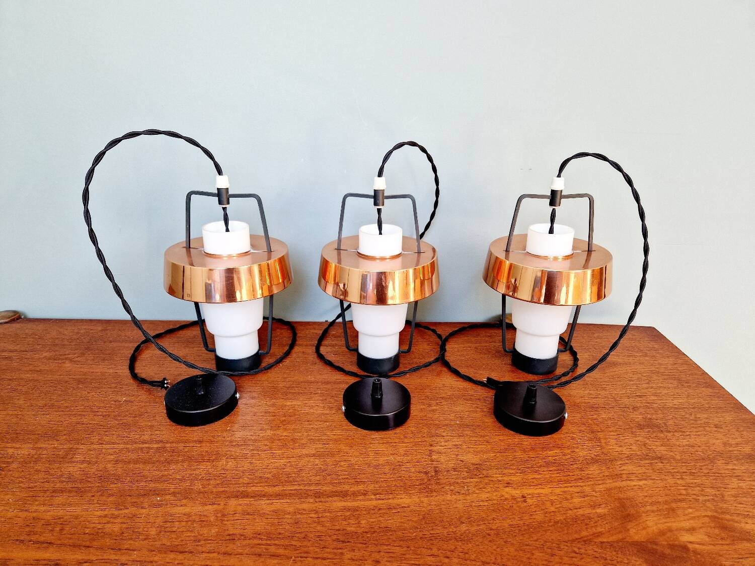 Trio of Scandinavian pendant lights in opaline and copper metal, 1960s