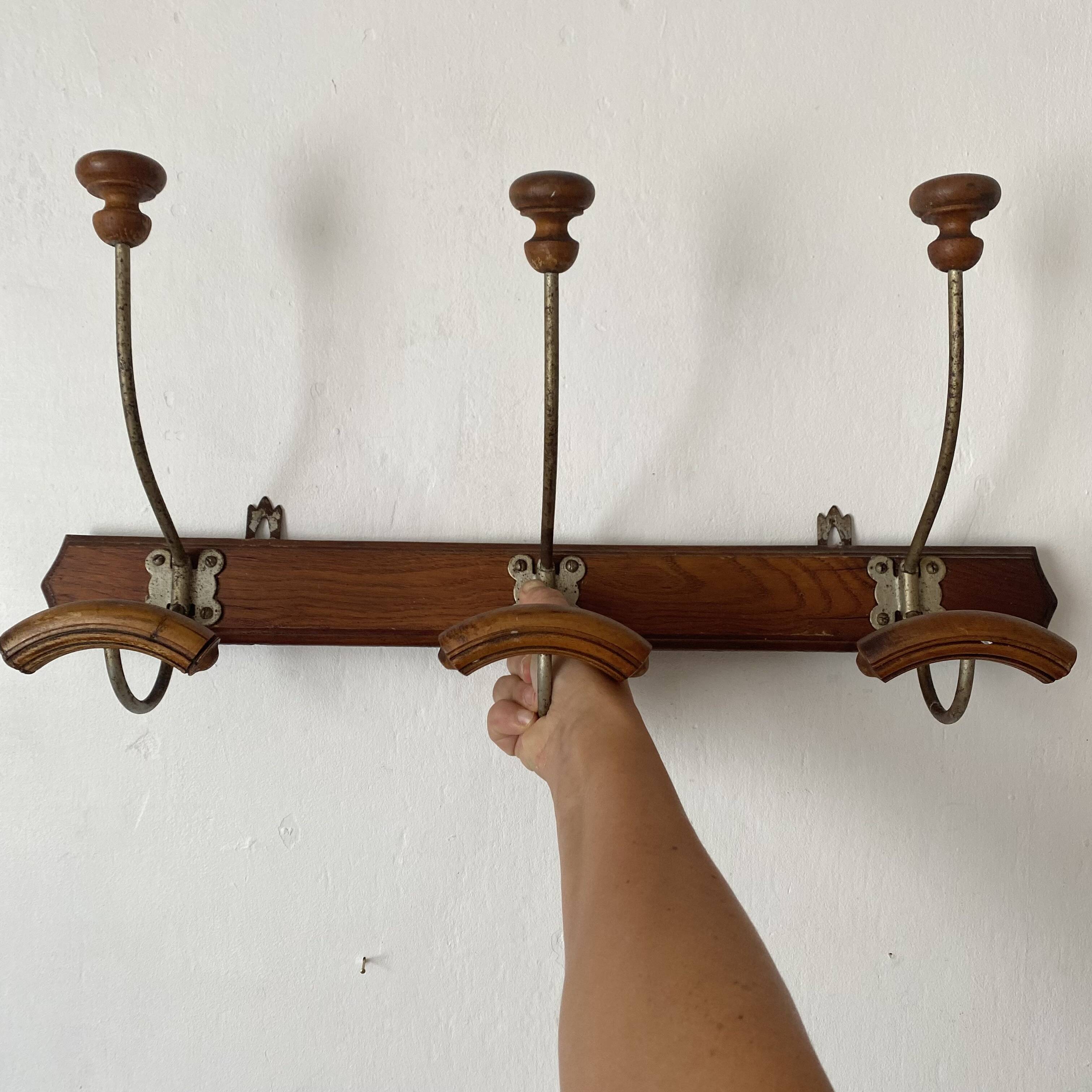 Antique wall-mounted coat rack in wood and metal