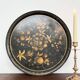 Round plateau, 19th century, painted black with fruit and grape decoration (49 cm)