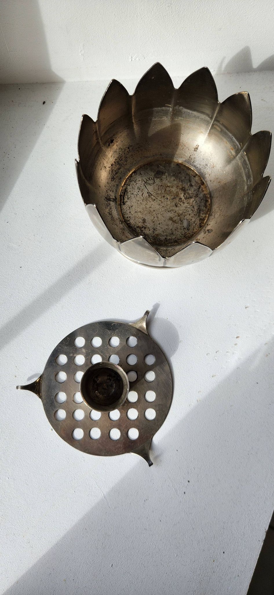 Picture of a lotus flower with a silver metal candlestick.