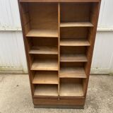 Oak two-column filing cabinet with curtains.