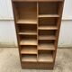 Oak two-column filing cabinet with curtains.