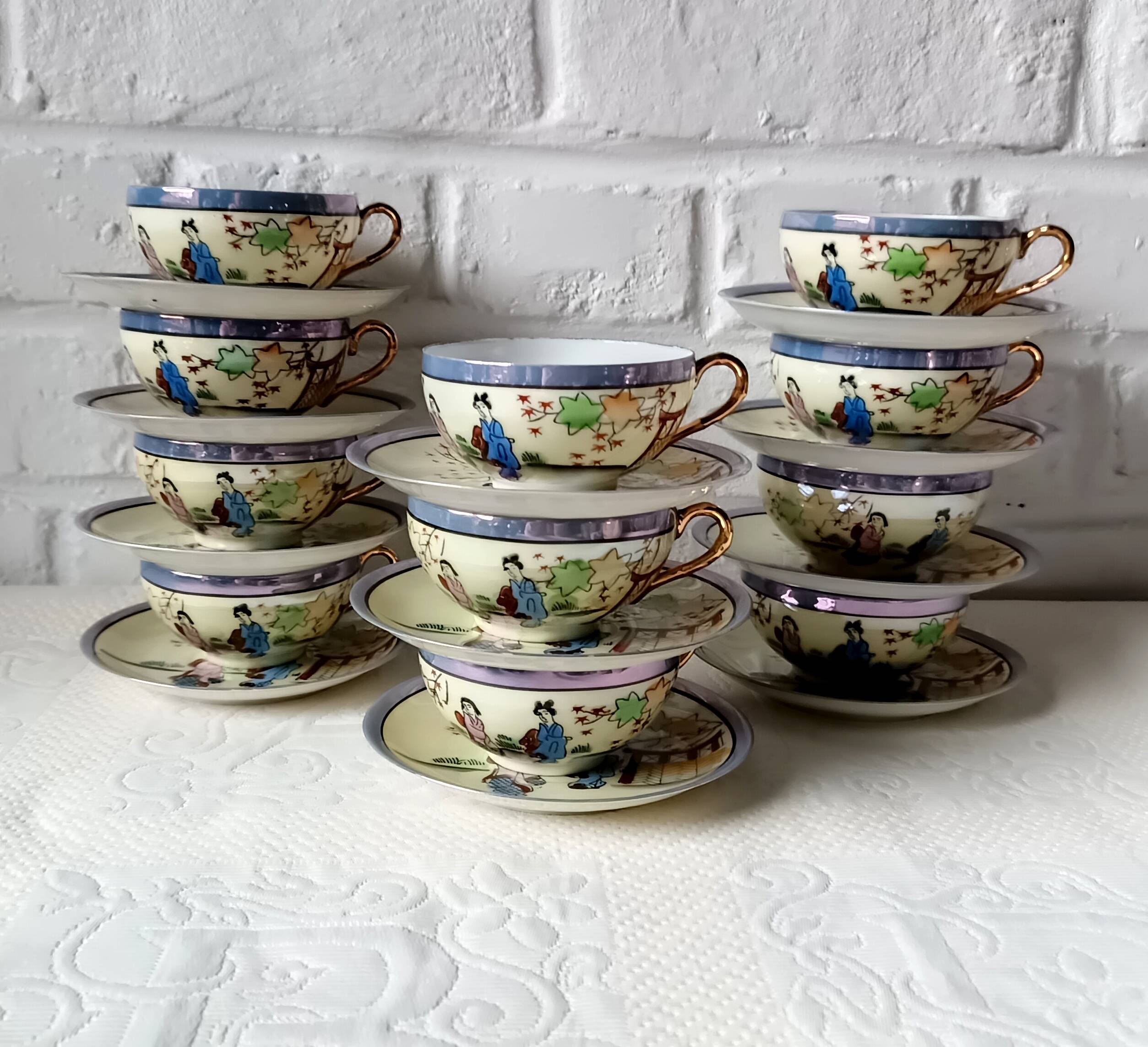 Vintage Japanese fine porcelain tea set with landscape pattern.