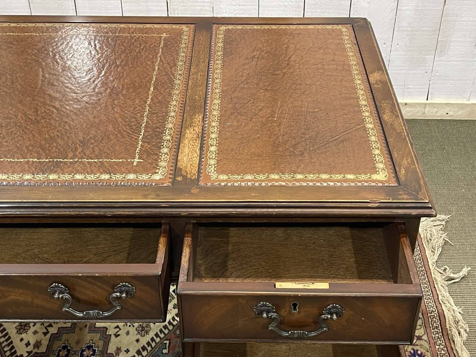 English mahogany pedestal desk with leather top from the 1950s