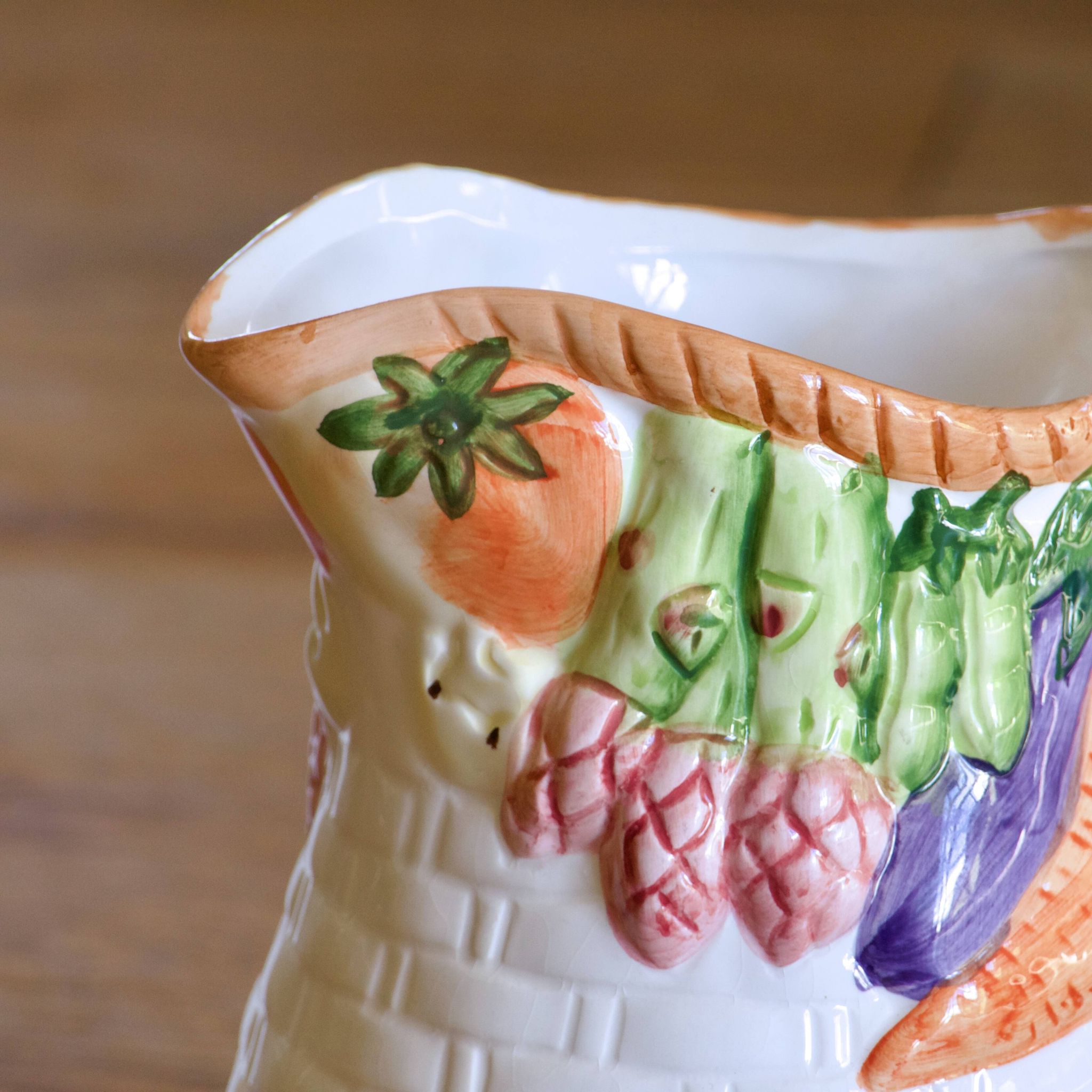 Hand-painted earthenware carafe with a raised vegetable basket design