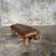 Small stool, footrest in blond teak, organic monoxyle with cut corners.