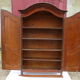 Small solid wooden cabinet with a gendarme hat