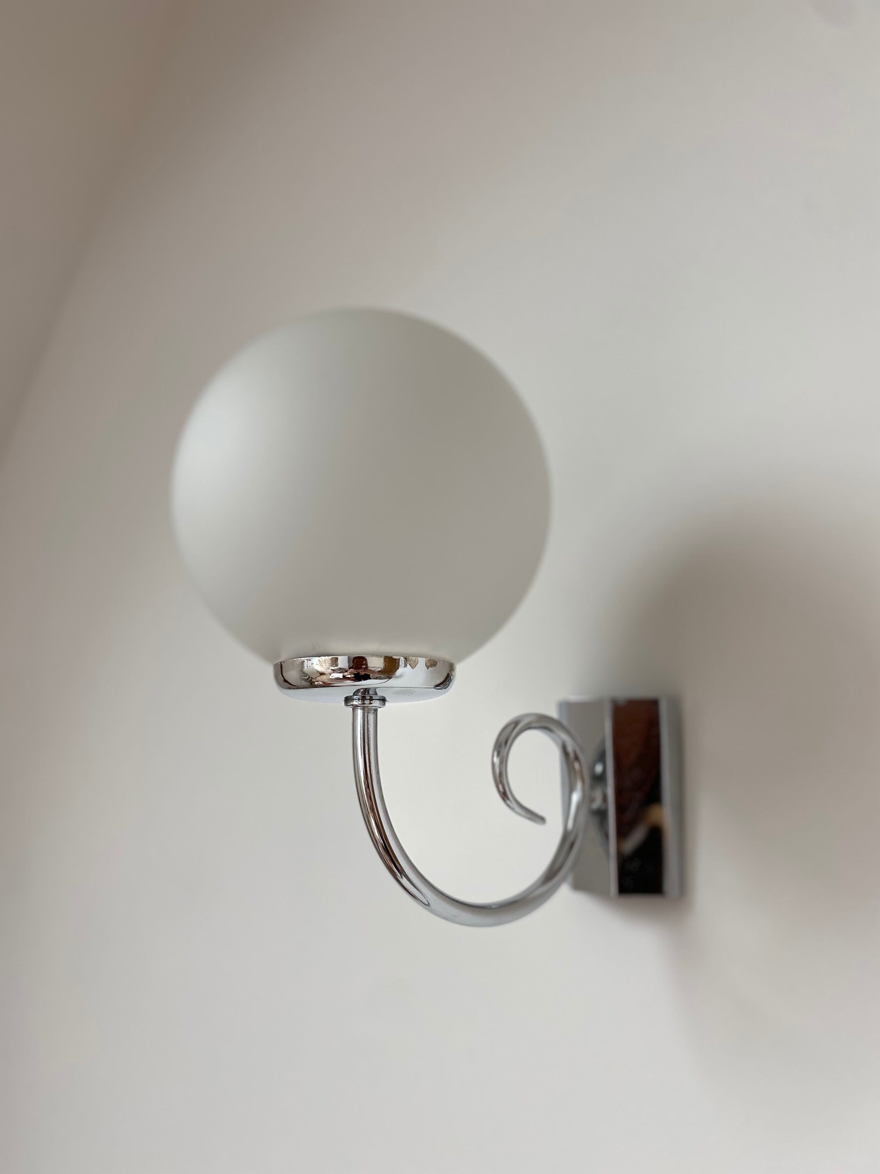 Pair of chrome and opaline metal wall lamps