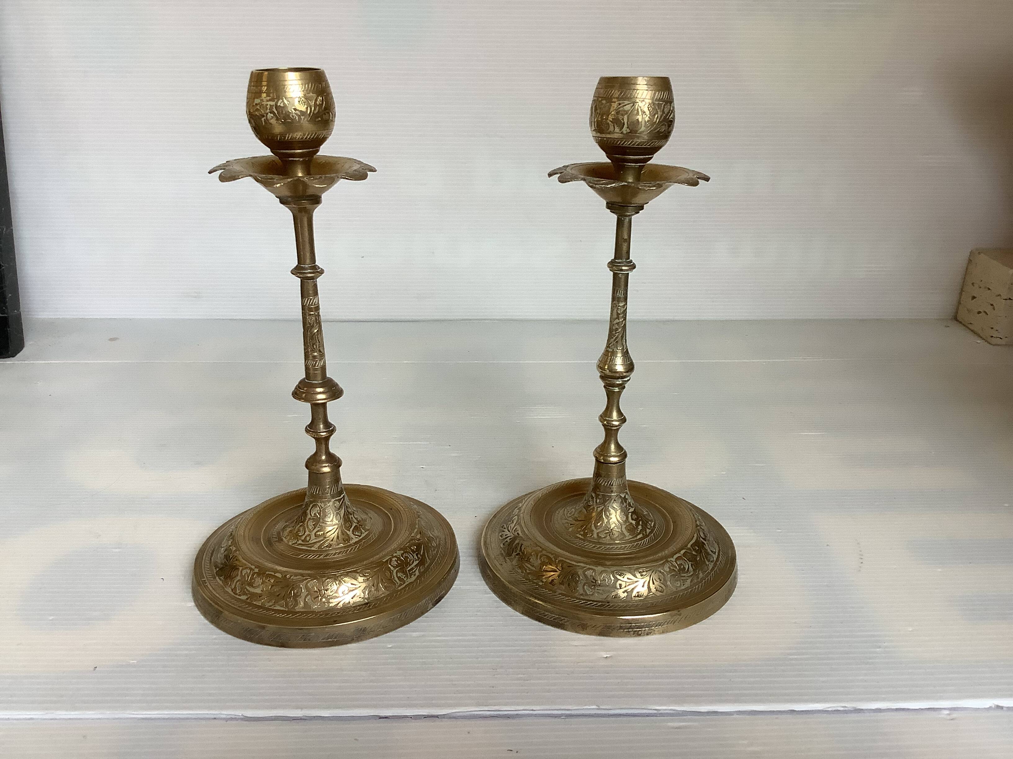 Pair of brass candlesticks with worked flower balls.