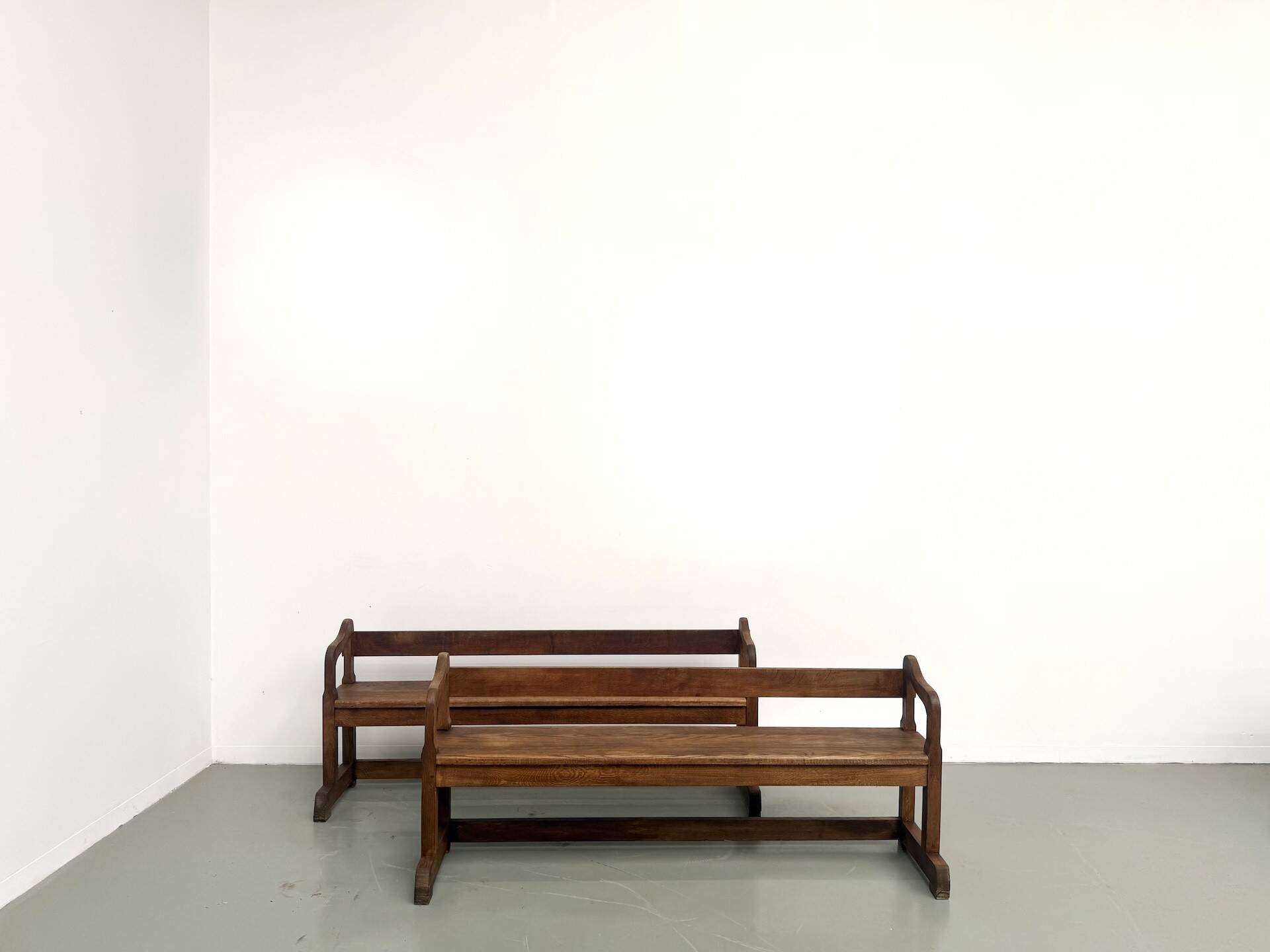 Pair of communal benches in solid oak, 1950s.