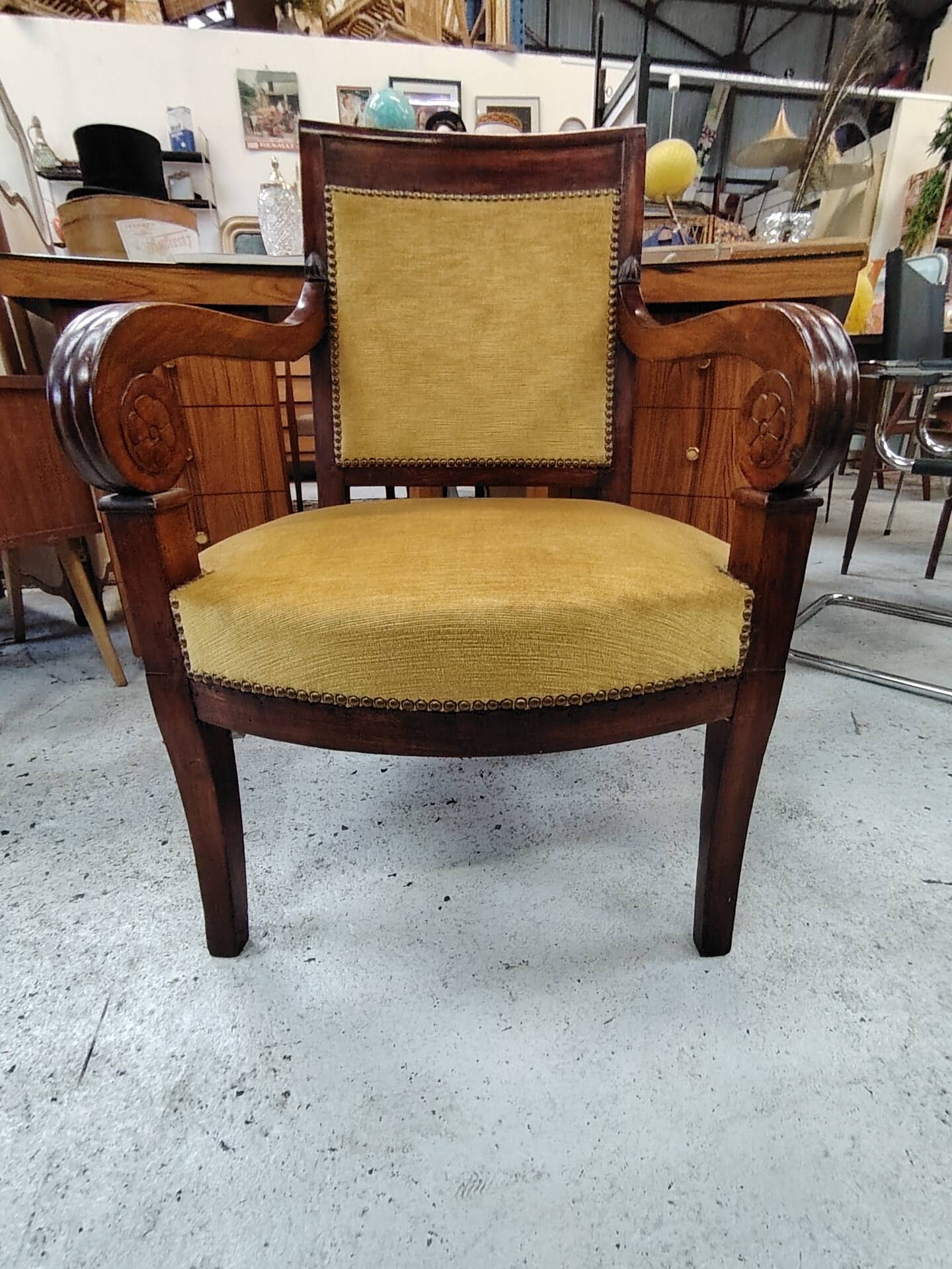 Armchair with scroll arms and sabre legs in mustard velvet, 19th century.
