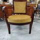 Armchair with scroll arms and sabre legs in mustard velvet, 19th century.