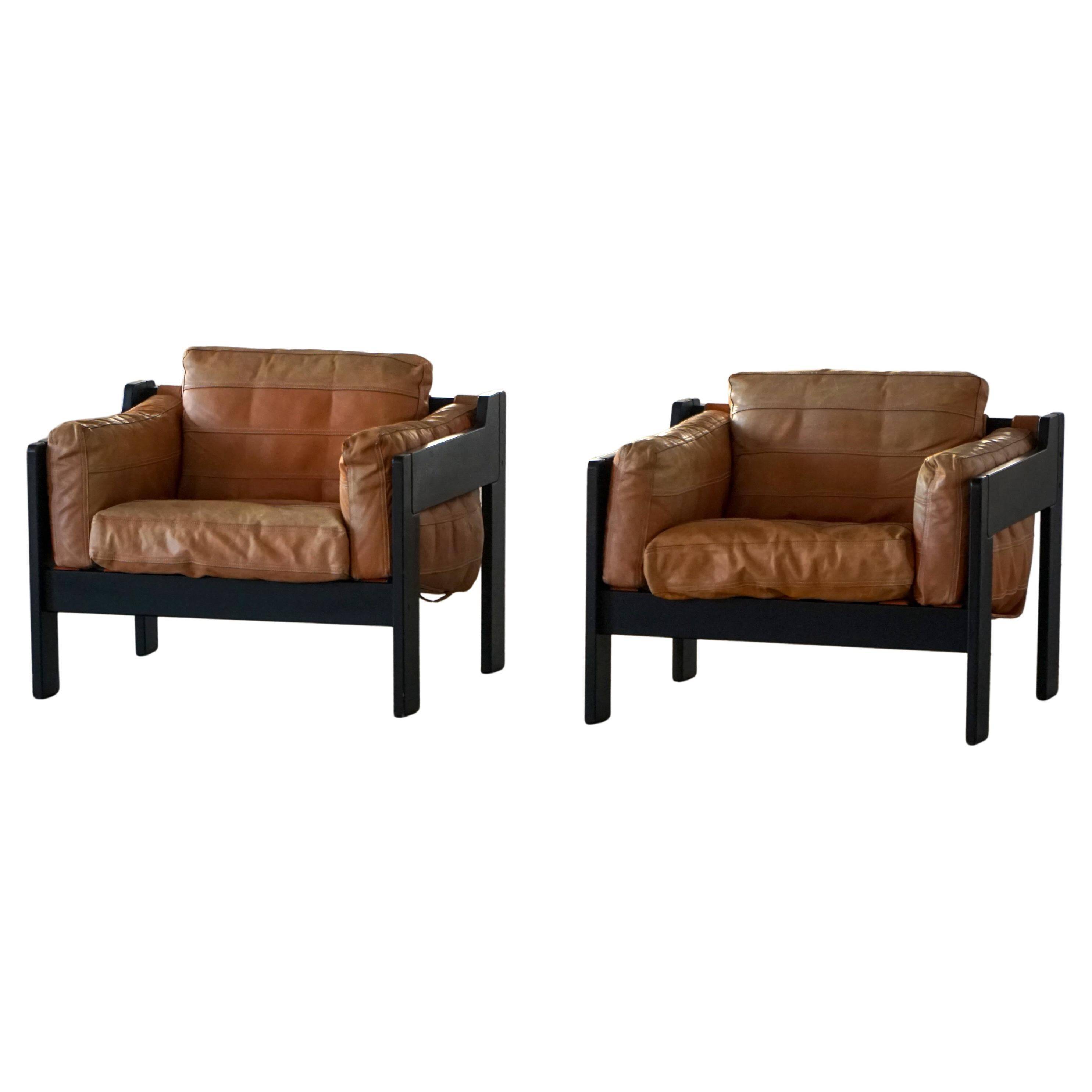 Pair of wooden and leather armchairs by Rud Thygesen & Johnny Sørensen, 1970s.