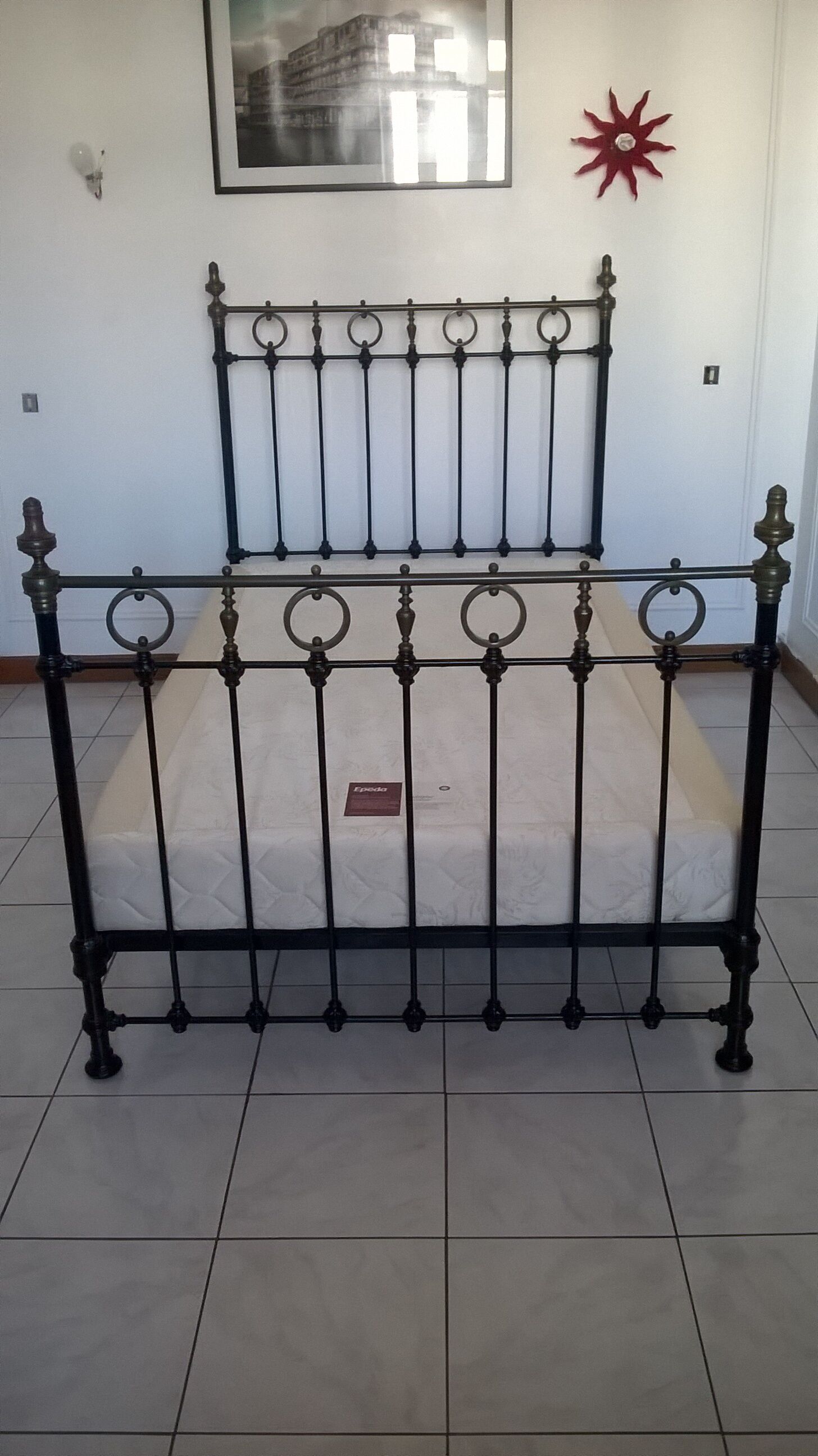 Old bed in black iron and brass