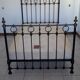 Old bed in black iron and brass