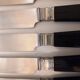 12 black Empire style table knives with silver ferrule Gimel