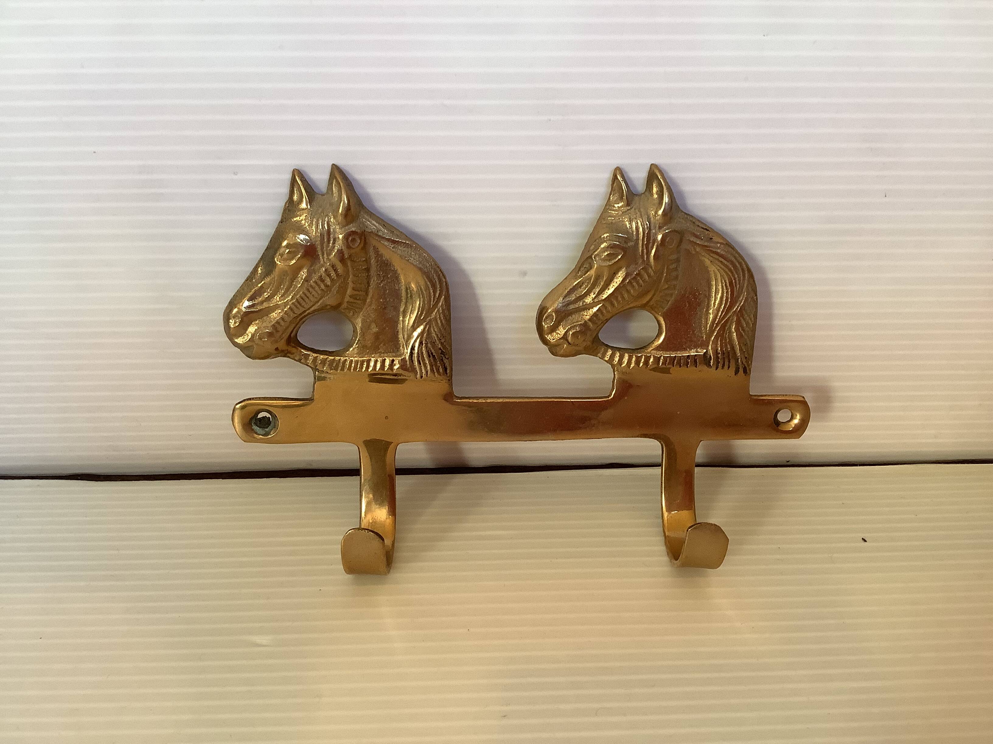 Wall-mounted coat rack with horses in brass