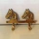 Wall-mounted coat rack with horses in brass