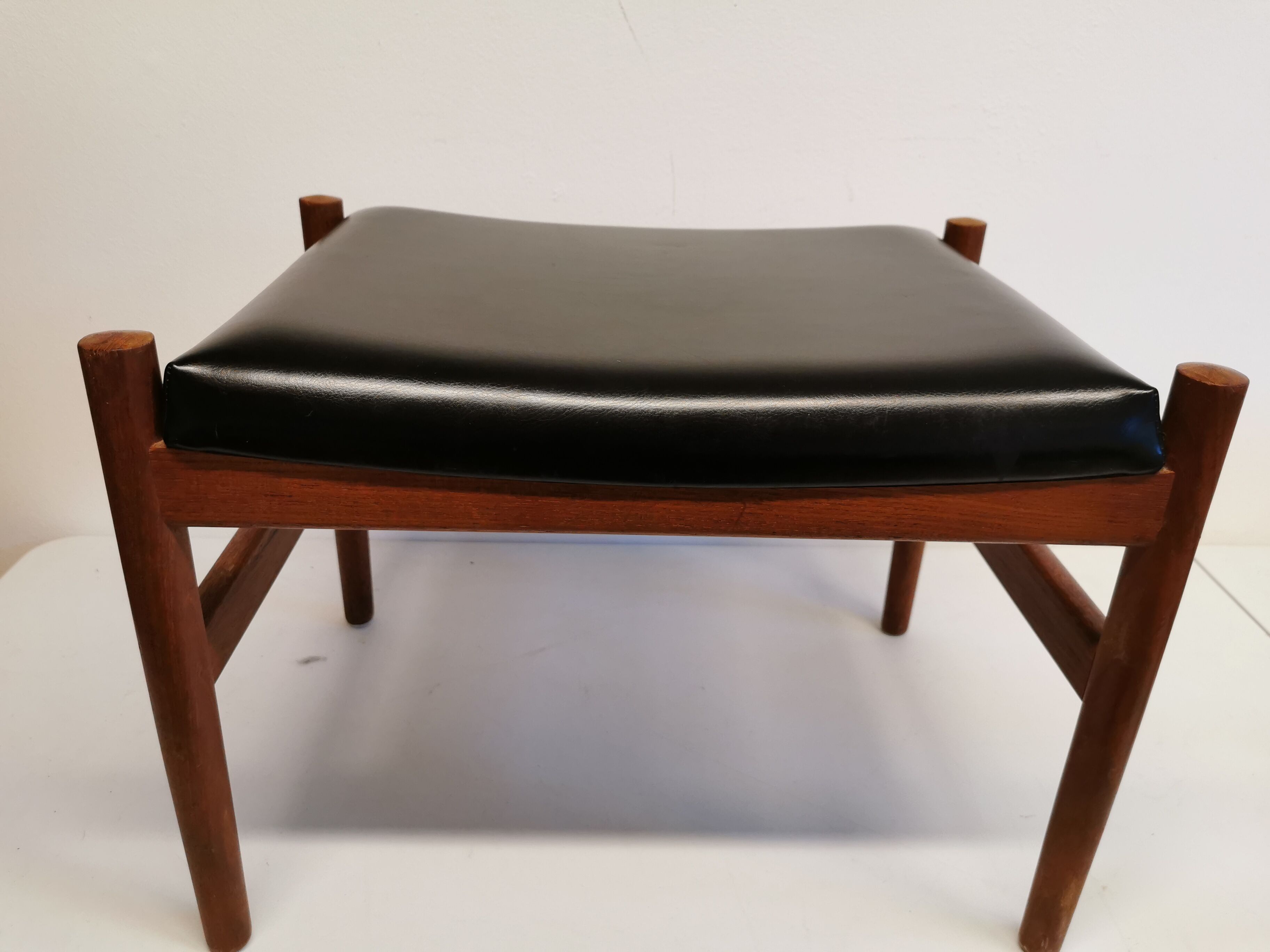 Danish designed footstool, in teak and black skai. Made at Spøttrup furniture factory in the 1960s.
