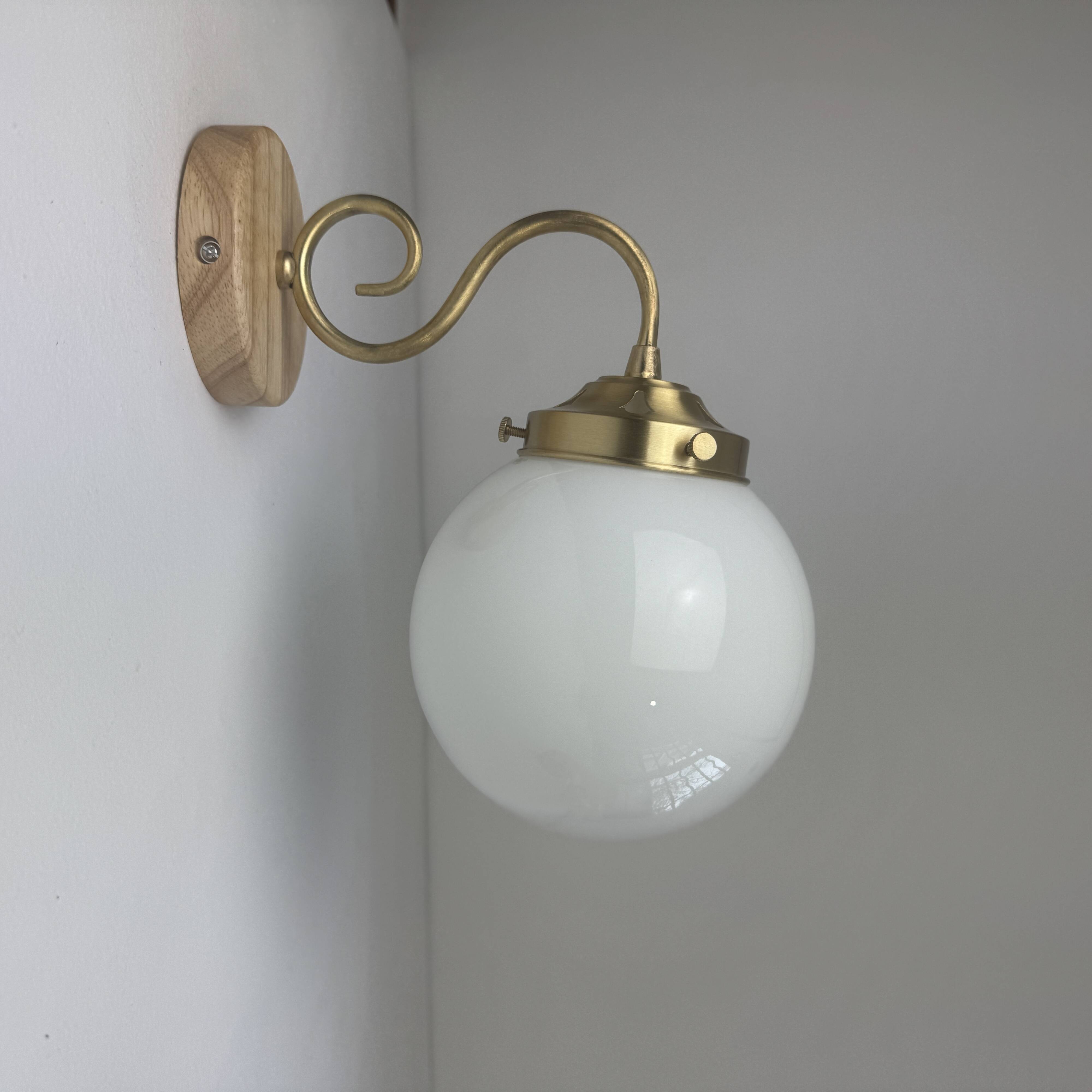 A pair of vintage opaline and brass wall lights