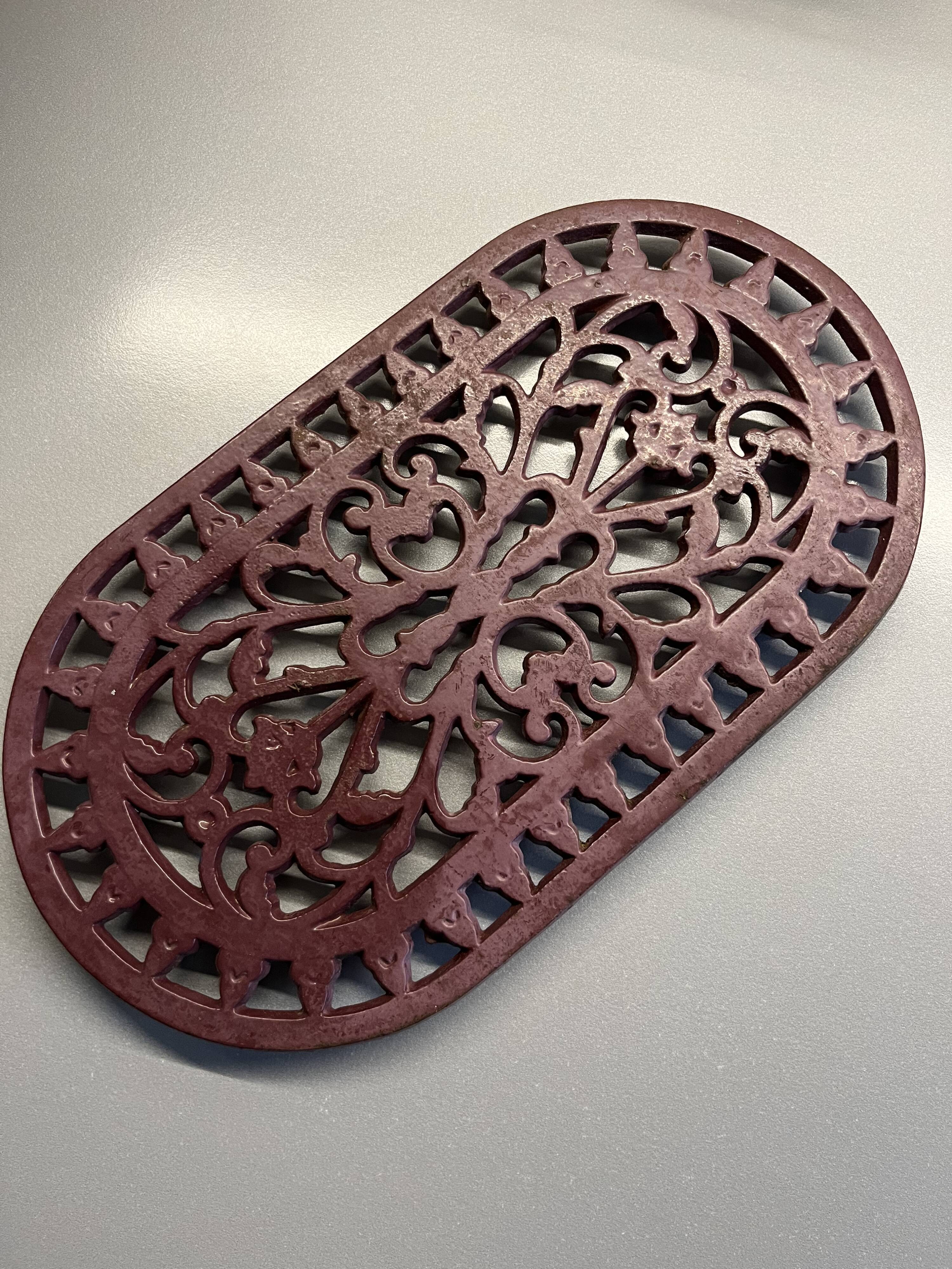 Old cast iron table mat