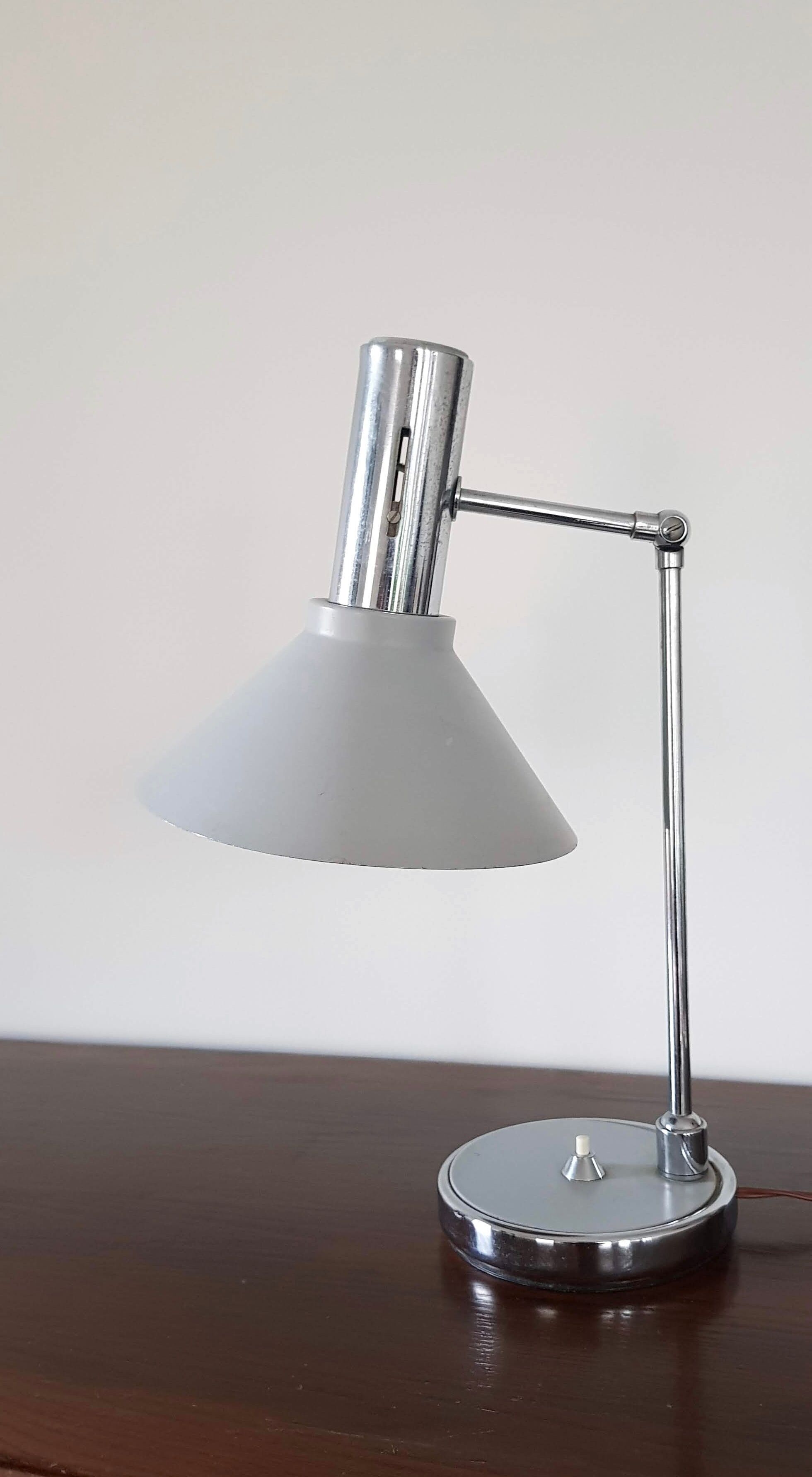Chrome metal desk lamp and gray articulated arm
