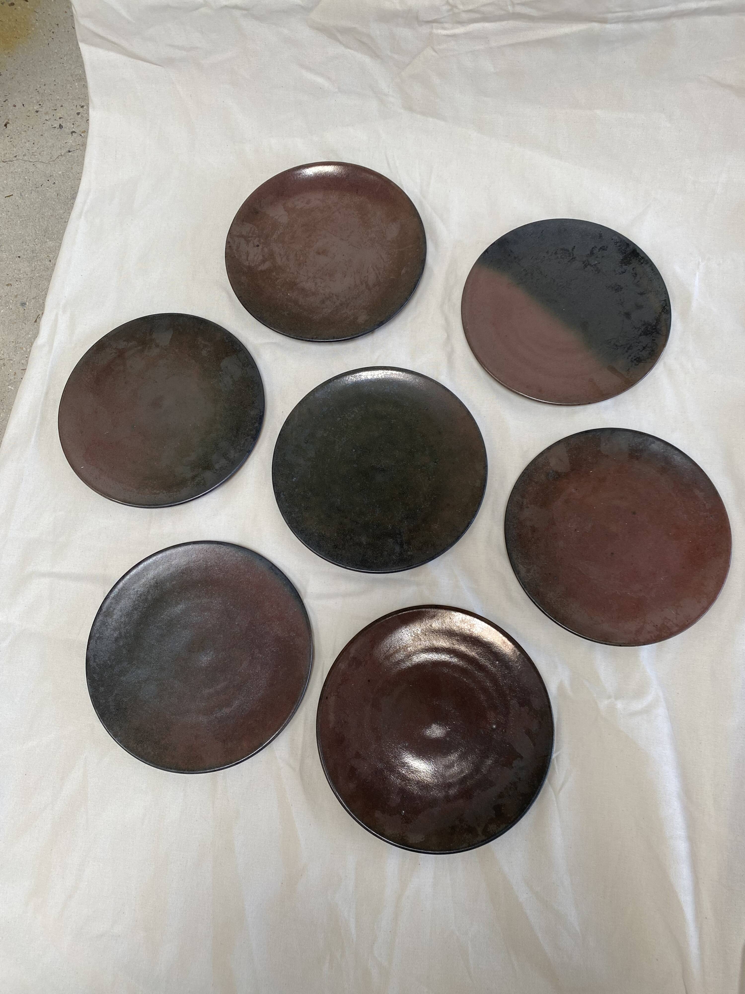 Series of 7 brown ceramic plates