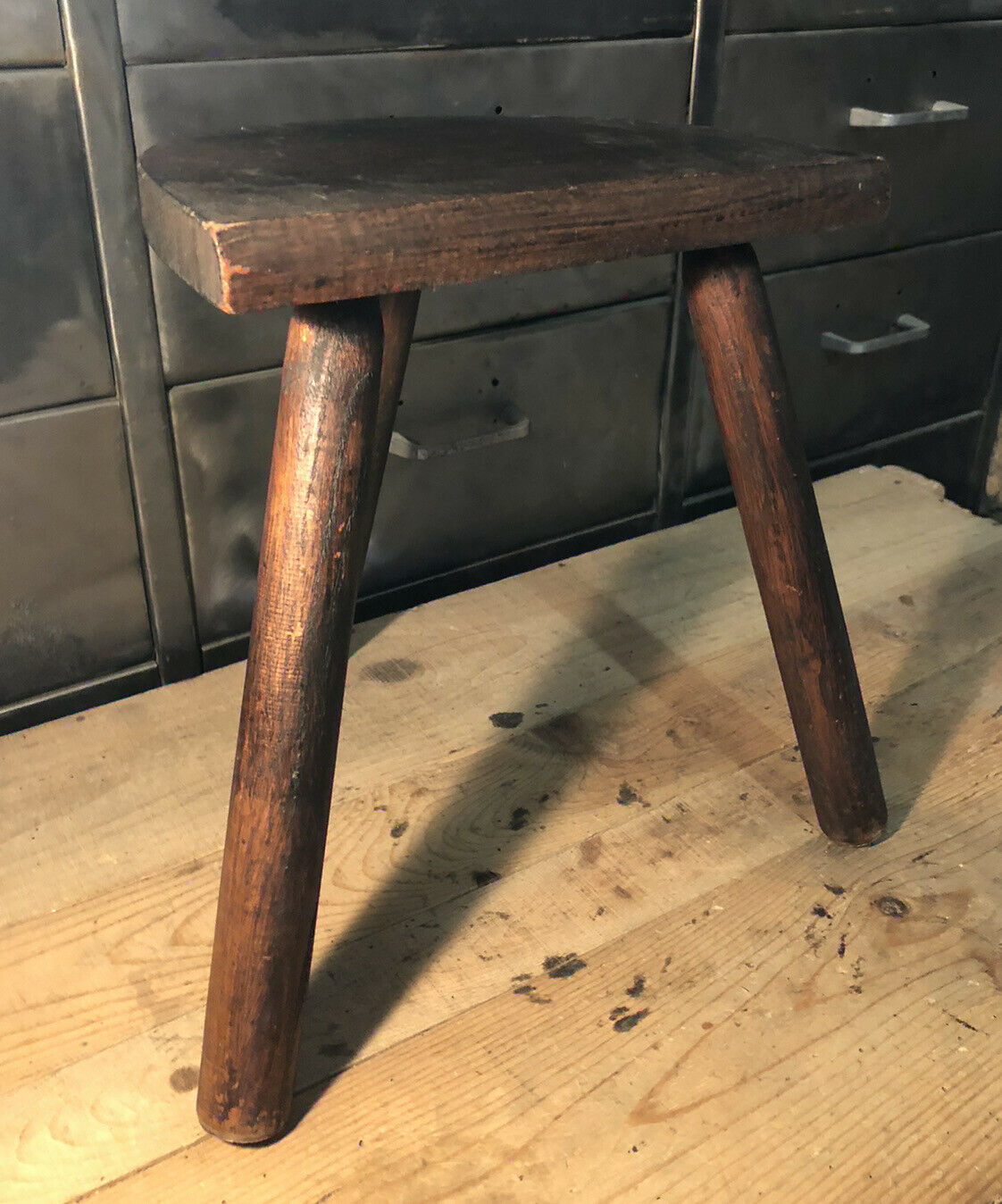 Wooden milking stool on tripod base