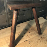 Wooden milking stool on tripod base