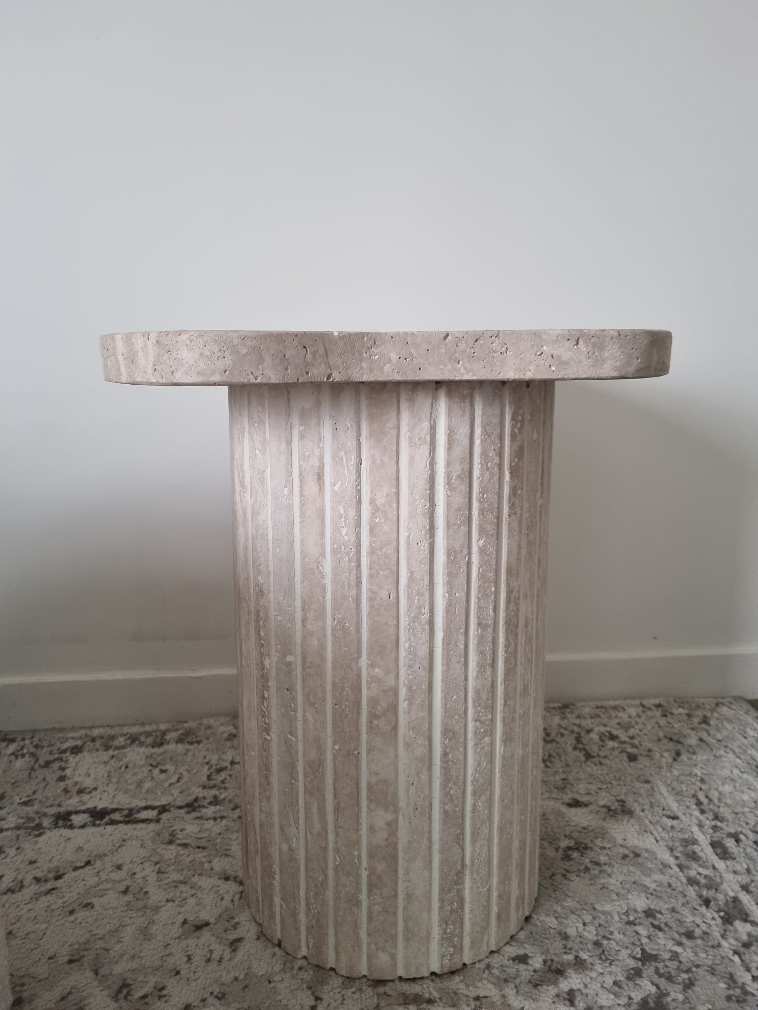 Alpha side table irregular natural travertine ribbed foot