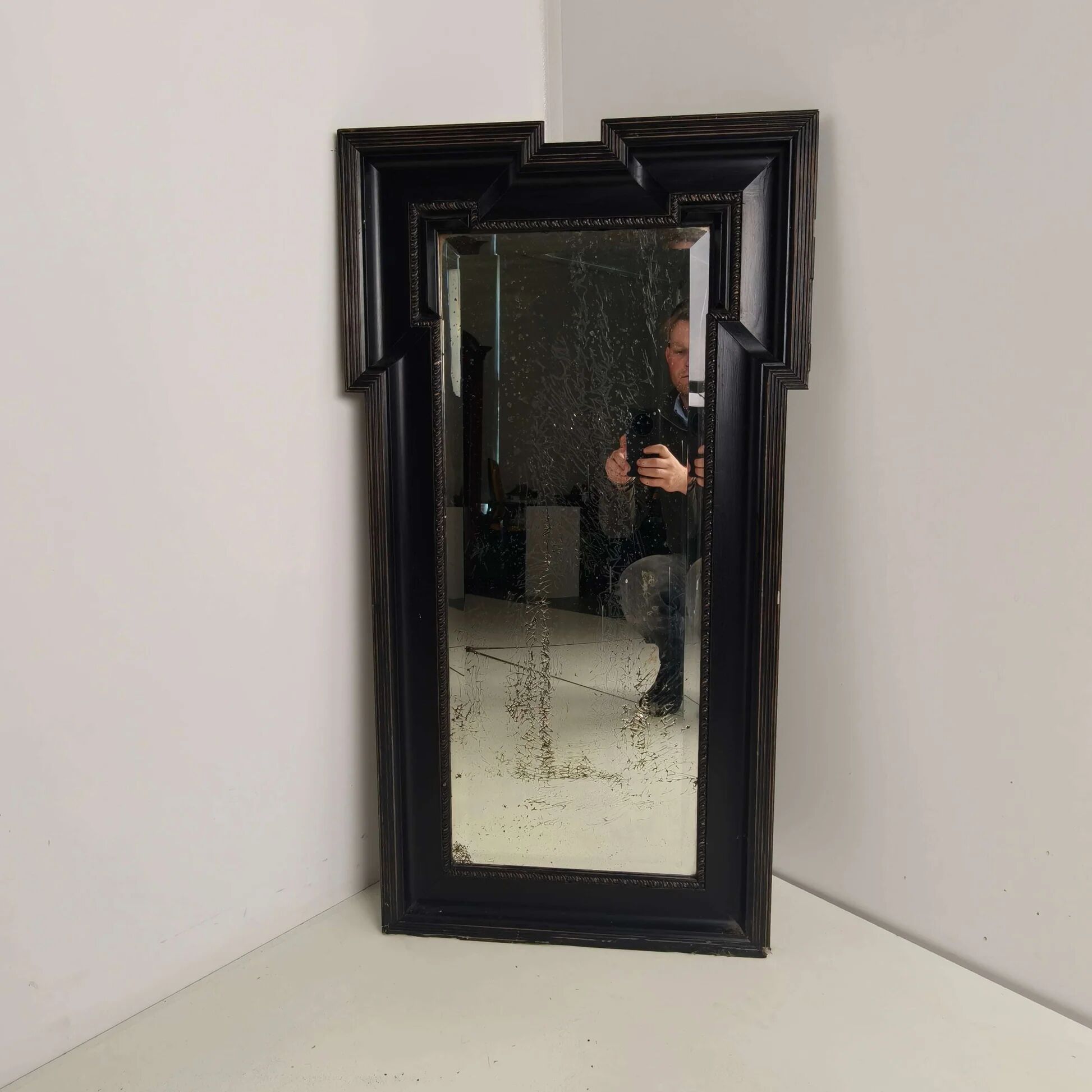 Late 19th century ebonised mirror with original foxed glass