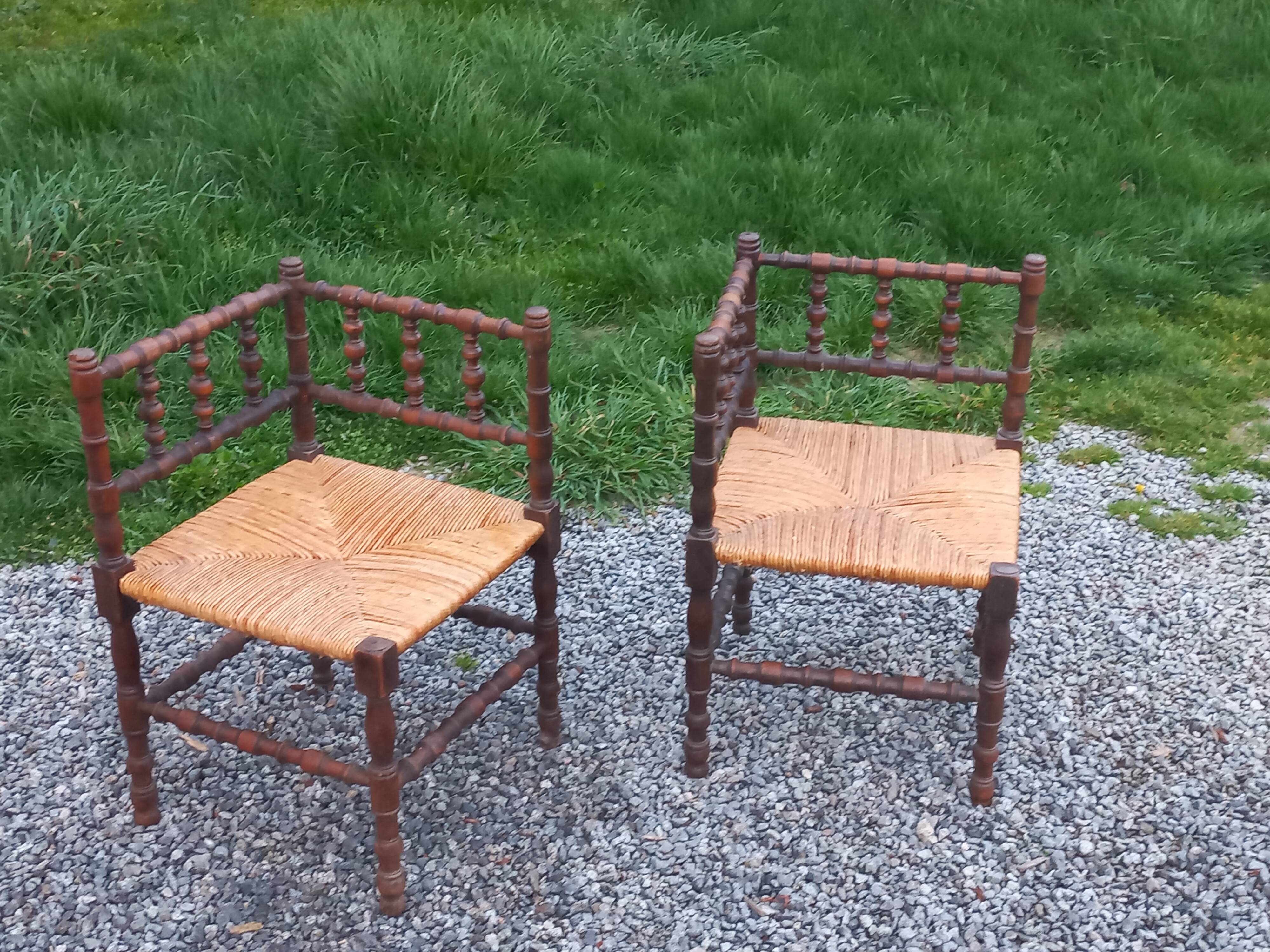 Pair of angled armchairs with turned wood and rush seats from the 1960s.
